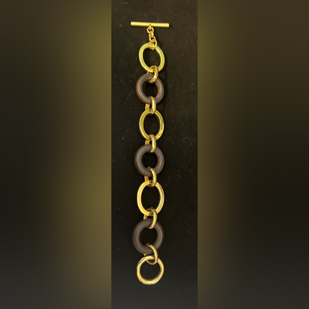 Women’s Metal and Faux wood bracelet with toggle closure.